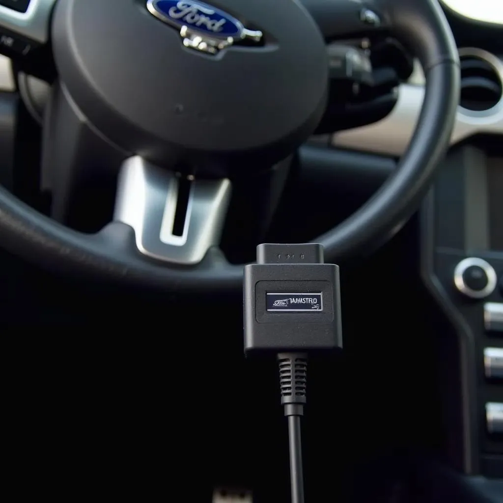 Un Ford code reader OBD1 cord connecté au port OBD1 d'une Ford Mustang