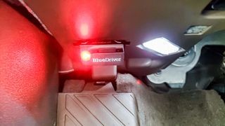 BlueDriver Bluetooth OBDII scanner showing red LED indicator during firmware recovery mode